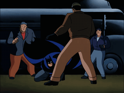 A Group Of Men Are Standing Around A Cartoon Character GIF