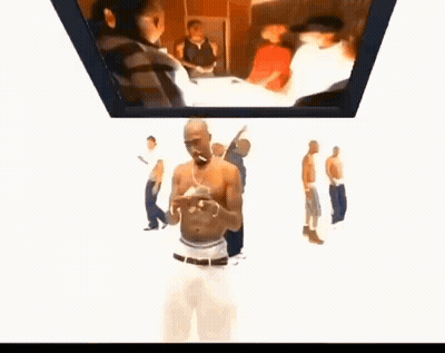 A Group Of Men Are Standing Around A Man Smoking A Cigarette In Front Of A Screen . GIF
