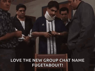 A Group Of Men Are Standing Around A Man Wearing A Neck Brace And A Shirt That Says Adidas GIF