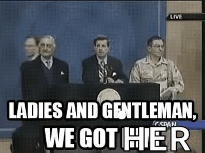 A Group Of Men Are Standing Behind A Podium Giving A Speech . GIF