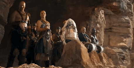 A Group Of Men Are Standing In A Cave With One Of Them Wearing A Wig GIF