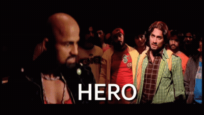 A Group Of Men Are Standing In A Crowd And The Word Hero Is On The Screen GIF
