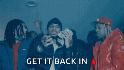 A Group Of Men Are Standing In A Dark Room With The Words " Get It Back In " On The Bottom Right GIF