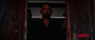 A Group Of Men Are Standing In A Hallway With The Word Brothers Written On The Bottom GIF