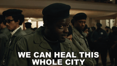 A Group Of Men Are Standing In A Line With The Words We Can Heal This Whole City On The Bottom GIF