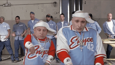 A Group Of Men Are Standing In A Room And One Of Them Has The Number 42 On His Jersey GIF