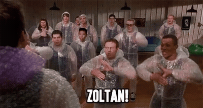 A Group Of Men Are Standing In A Room Wearing Plastic Bubble Wrap And Dancing . GIF