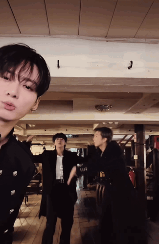 A Group Of Men Are Standing In A Room With A Ceiling That Has A Hook On It GIF