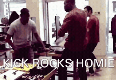 A Group Of Men Are Standing In A Store With The Words Kick Rocks Homie On The Bottom GIF