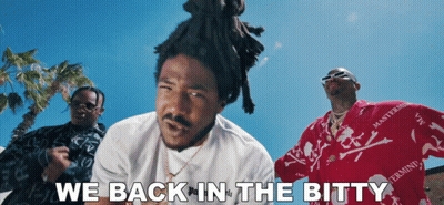 A Group Of Men Are Standing In Front Of A Blue Sky With The Words " We Back In The Bitty " GIF