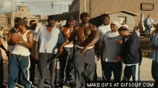 A Group Of Men Are Standing In Front Of A Building And Dancing . GIF