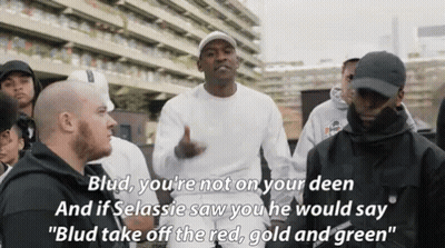 A Group Of Men Are Standing In Front Of A Building And One Of Them Says Blud You 'Re Not On Your Deen . GIF