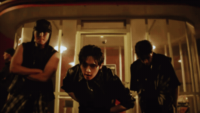 A Group Of Men Are Standing In Front Of A Door That Says No Parking GIF