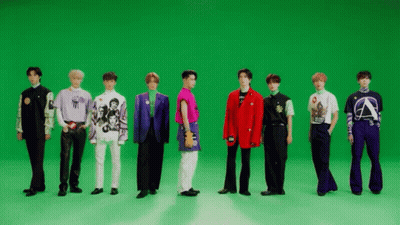 A Group Of Men Are Standing In Front Of A Green Screen . GIF