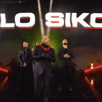 A Group Of Men Are Standing In Front Of A Large Sign That Says Lo Siko GIF