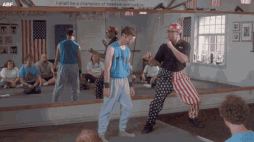 A Group Of Men Are Standing In Front Of A Mirror With A Sign That Says I Shall Be A Champion Of GIF