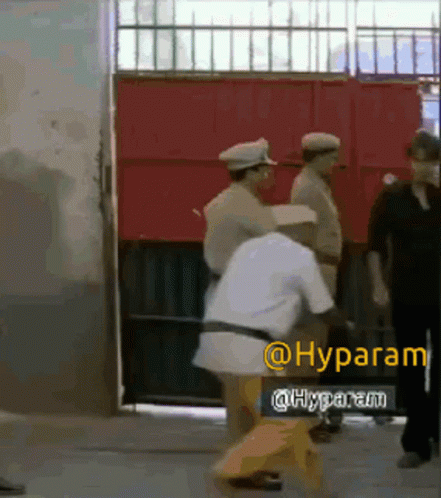 A Group Of Men Are Standing In Front Of A Red Door With A Sign That Says @Hyparam GIF