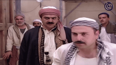 A Group Of Men Are Standing In Front Of A Sign That Says ' Cy ' On It GIF