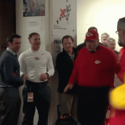 A Group Of Men Are Standing In Front Of A Wall That Has A Prof Sign On It GIF