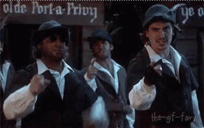 A Group Of Men Are Standing In Front Of An Olde Port-A-Privy Sign . GIF
