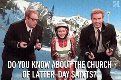 A Group Of Men Are Standing Next To A Woman In A Ski Suit And Asking Her About The Church Of Latter-Day Saints GIF