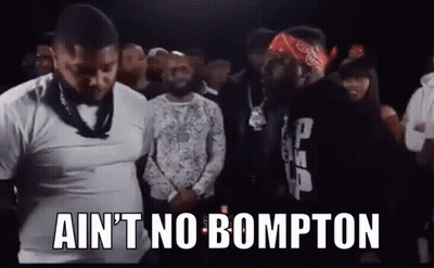 A Group Of Men Are Standing Next To Each Other In A Crowd And One Of Them Is Wearing A Bandana . GIF