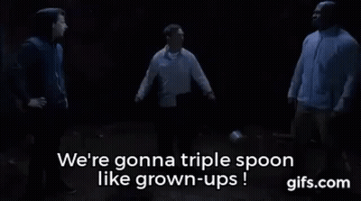A Group Of Men Are Standing Next To Each Other In A Dark Room And Talking About Triple Spoon Like Grown-Ups . GIF