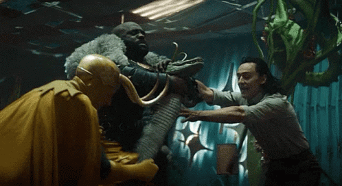 A Group Of Men Are Standing Next To Each Other In A Dark Room Holding Hands . GIF