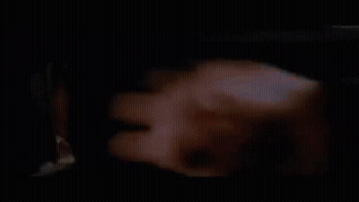 A Group Of Men Are Standing Next To Each Other In A Dark Room Looking Through A Window . GIF