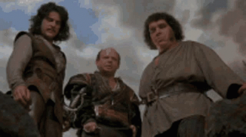 A Group Of Men Are Standing Next To Each Other In A Field . GIF