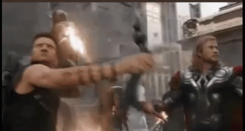 A Group Of Men Are Standing Next To Each Other In A Room . GIF