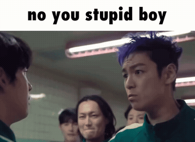 A Group Of Men Are Standing Next To Each Other In A Room And One Of Them Has Blue Hair . GIF