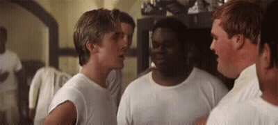A Group Of Men Are Standing Next To Each Other In A Room And Talking . GIF