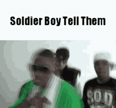 A Group Of Men Are Standing Next To Each Other In A Room . GIF