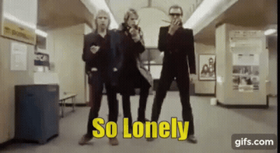 A Group Of Men Are Standing Next To Each Other In A Room With The Words `` So Lonely '' Written On The Screen . GIF