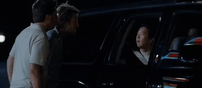 A Group Of Men Are Standing Next To Each Other In Front Of A Car With The Word Toodaloo On The Bottom . GIF