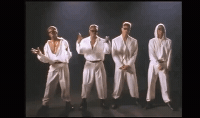 A Group Of Men Are Standing Next To Each Other On A Stage And Dancing . GIF