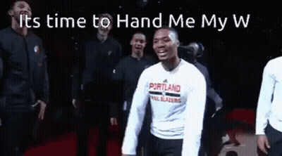 A Group Of Men Are Standing Next To Each Other On A Stage . GIF