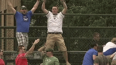 A Group Of Men Are Standing On A Fence With Their Arms In The Air GIF