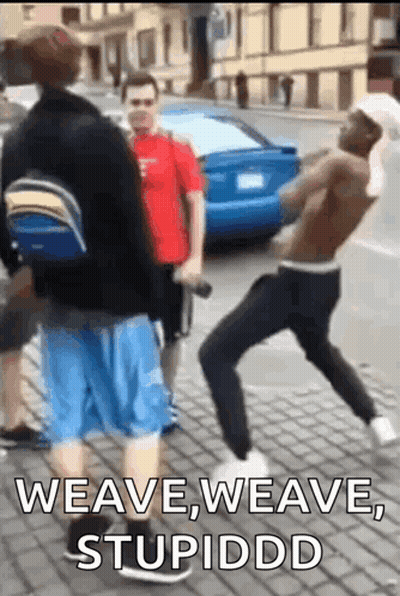 A Group Of Men Are Standing On A Sidewalk And One Of Them Says Weave Weave Stupiddd . GIF