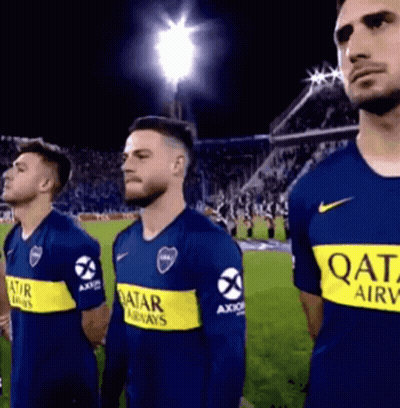 A Group Of Men Are Standing On A Soccer Field Wearing Qatar Airways Shirts . GIF