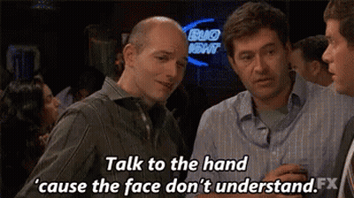 A Group Of Men Are Talking To Each Other In A Bar . GIF