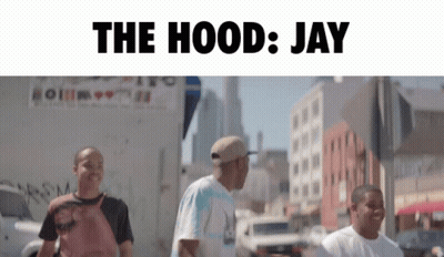 A Group Of Men Are Walking Down A Street With The Words " The Hood Jay " Above Them GIF