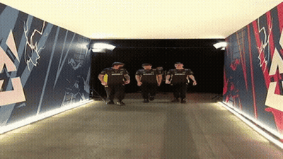 A Group Of Men Are Walking Through A Tunnel That Has A Mural On The Wall That Says Summit GIF