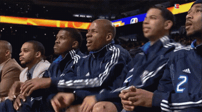 A Group Of Men Are Watching A Basketball Game And One Of Them Has The Number 2 On His Jacket GIF