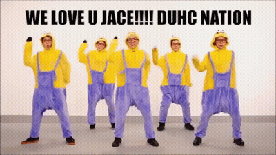 A Group Of Men Dressed As Minions Are Dancing In Front Of A Sign That Says We Love U Jace !!! Duhc Nation GIF