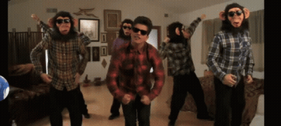 A Group Of Men Dressed As Monkeys Are Dancing In A Living Room GIF
