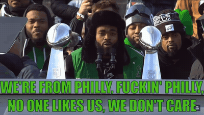 A Group Of Men Holding Trophies And A Sign That Says We 'Re From Philly Fuckin Philly No One Likes Us GIF