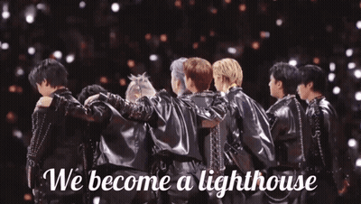 A Group Of Men Huddled Together With The Words " We Become A Lighthouse " On The Bottom GIF