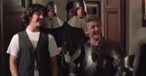 A Group Of Men In Armor Are Standing Next To Each Other And Laughing . GIF